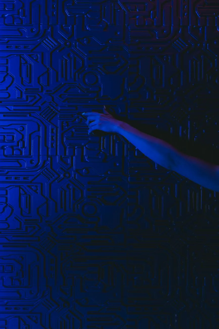A hand reaching toward a glowing blue circuit-patterned wall